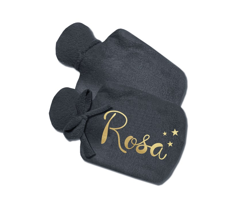 May include: A dark gray fleece hot water bottle with a gold inscription that reads "Rosa" and three gold stars.