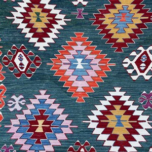 May include: A traditional Turkish rug with a geometric pattern in shades of red, blue, white, and green. The rug features a repeating design of diamonds and squares.