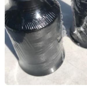 May include: Two spools of black thread wrapped in clear plastic.