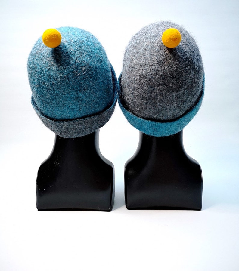 Rough edged graphite grey or teal blue bobble close fitting beanie hat natural wool saunaoutdoors charcoal gray cloche with a orange bobble