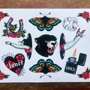 May include: A set of nine traditional tattoo flash designs. The designs include a horseshoe, a panther, a butterfly, a heart with the word "loner", a lighter with the year 1993, a pair of fangs, and a woman's leg and arm emerging from a black hole.