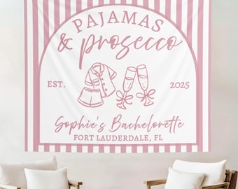 Peut inclure: Une tapisserie à rayures roses et blanches avec les mots "PAJAMAS & prosecco" dans une arche décorative. La tapisserie comprend des illustrations de pyjamas et de flûtes à champagne, avec le texte "Sophie's Bachelorette, Fort Lauderdale, FL."