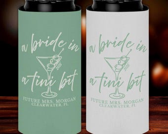 May include: Two can coolers, one mint green and one white, with black tops. Each cooler has the text "a bride in a tini bit" with a martini glass graphic and "Future Mrs. Morgan Clearwater, FL" below.