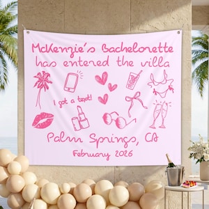 May include: A light pink fabric banner featuring dark pink line art illustrations of a palm tree, smartphone, hearts, drink, bikini, lipstick, sunglasses, and champagne flutes. The text reads: McKenzie's Bachelorette has entered the villa, I got a text!, Palm Springs, CA, February 2026.