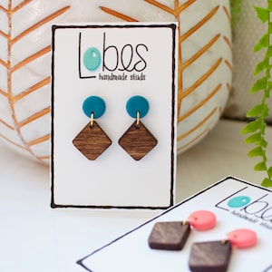 May include: Teal and brown geometric earrings with the text "Lobes handmade studs" on a white card.