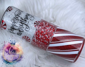 May include: A red and white striped tumbler with silver glitter and the text "Peppermint everything" in black script. The tumbler has a candy cane design.