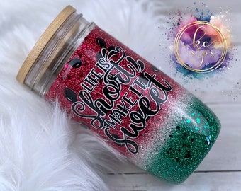 May include: A red, white, and green glitter tumbler with a bamboo lid. The tumbler has the text "Life is short make it sweet" printed on it.