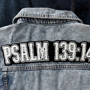 May include: A blue denim jacket with a black and white patch that says "PSALM 139:14" on the back.