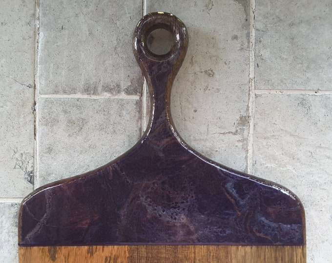 Wooden serving board with handle featuring purple resin art