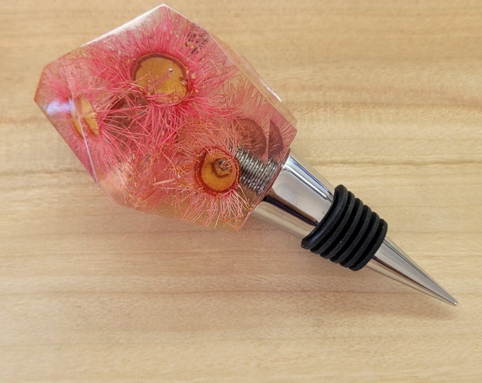 Resin wine bottle stopper with embedded dried flowers including Australian flowering gum, strawflowers, dandelion, gomphrena & Golden Penda