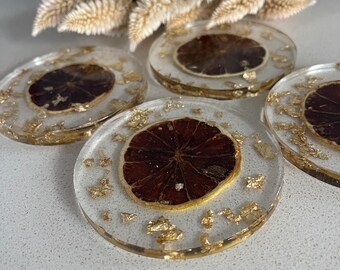 Set of four round resin coasters with real dried lime slices and gold foil