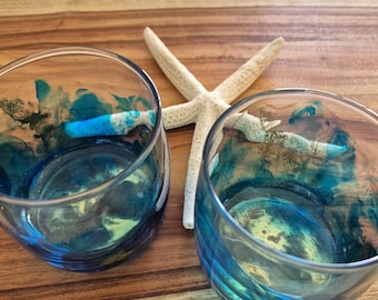Glass tumblers featuring blue and gold alcohol ink and resin artwork