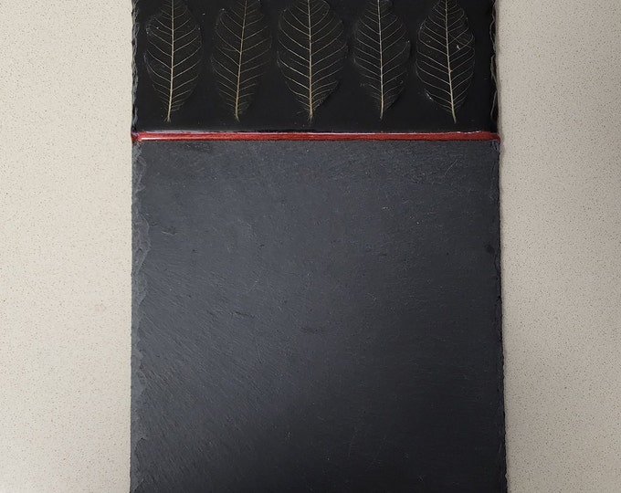 Slate stone serving board with leaf skeletons in resin with copper edging