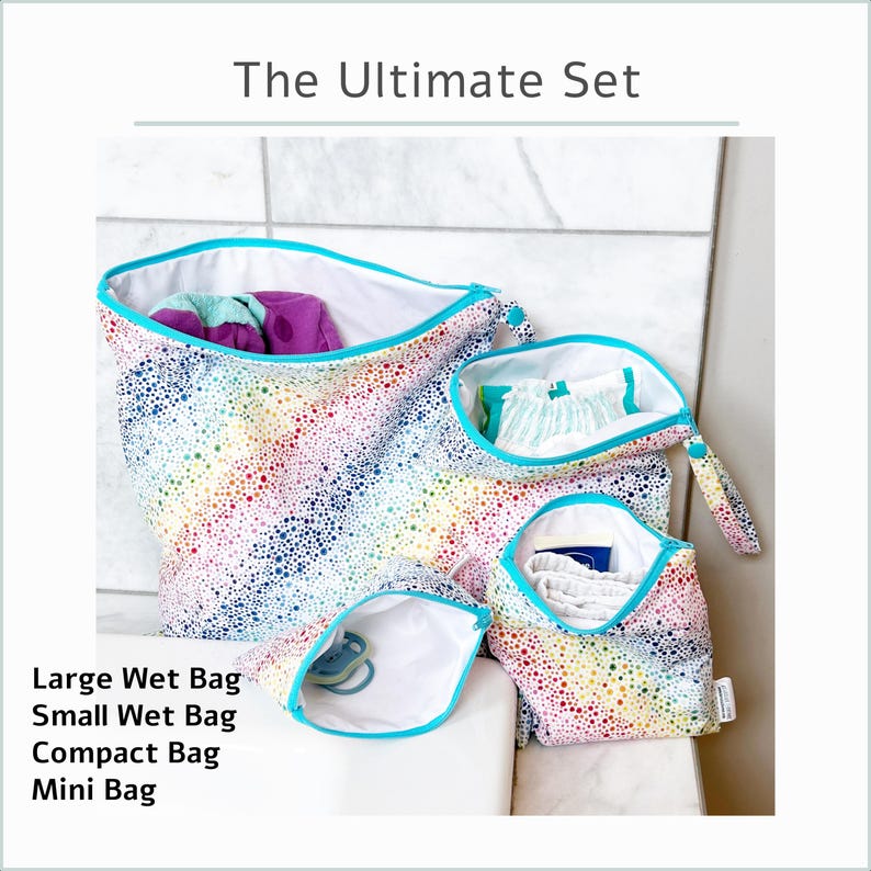 May include: The Ultimate Set of wet bags in a rainbow dot pattern. The set includes a large, small, compact, and mini bag. Each bag has a white interior and a teal zipper. The large bag contains purple items.