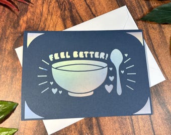 Navy blue and iridescent soup bowl and spoon feel better card, get better from a far note, cheer up card