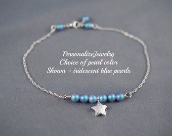 May include: A silver chain bracelet with a star charm and iridescent blue beads.  Personalize Jewelry Choice of pearl color Shown - iridescent blue pearls