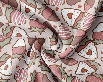 May include: A pink fabric with a repeating pattern of strawberries dipped in chocolate. The strawberries are drawn in a cartoon style with brown outlines and white chocolate swirls. The background is a light pink with small white hearts.