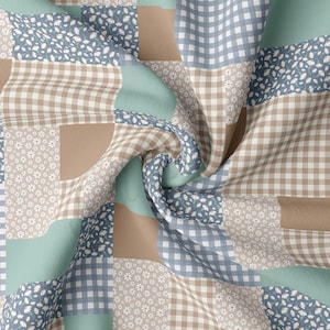 May include: A patchwork fabric with a variety of patterns, including gingham, floral, and solid colors. The fabric is in shades of blue, brown, and green.