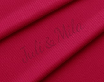 May include: Close-up of a deep red ribbed fabric with the text "Juli & Mila" printed on it.