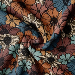 May include: A seamless fabric pattern featuring a repeating design of large, stylised flowers in shades of brown, rust, teal, and cream. The flowers have a textured, almost corduroy-like appearance.