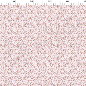 May include: A repeating pattern featuring white ghosts, orange circles, and purple star and triangle shapes on a pale pink backdrop. The design is evenly spaced, creating a playful, whimsical aesthetic, suitable for fabric or wallpaper.