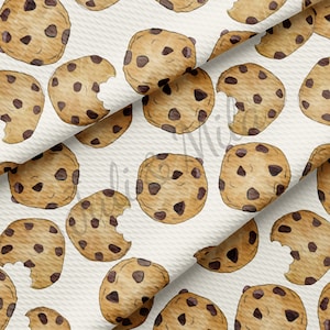 May include: A seamless pattern featuring watercolor illustrations of chocolate chip cookies on a white background. The cookies are arranged in a repeating pattern, with some cookies having a bite taken out of them.