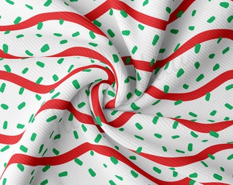 Peut inclure: Tissu blanc à rayures rouges et vertes. Le tissu présente un motif répétitif de tirets verts sur fond blanc. Les rayures rouges sont épaisses et ondulées.