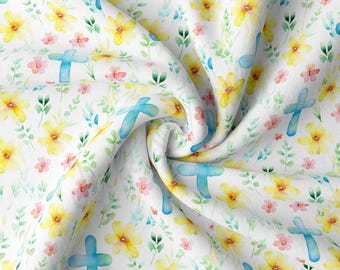 May include: White fabric with a repeating pattern of blue crosses, yellow flowers, and green leaves.