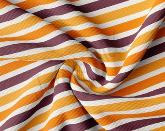 May include: Striped fabric with alternating bands of white, orange, and maroon. The fabric is folded and textured.