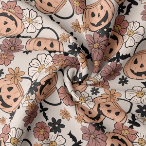 May include: A white fabric with a repeating pattern of orange jack-o'-lantern pumpkins with black eyes and mouths, and brown and white flowers.