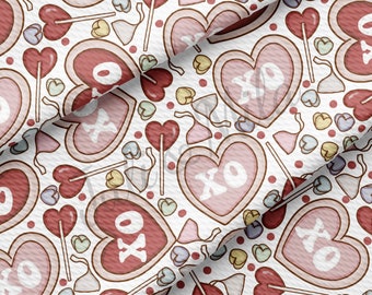 May include: A seamless pattern featuring pink and red hearts with "XO" written inside, along with candy hearts, lollipops, and bows on a white background.