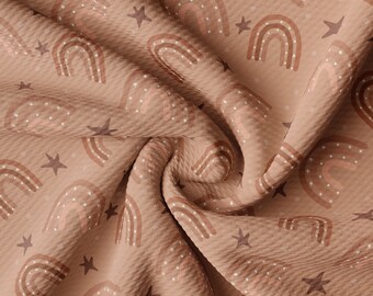 May include: A brown fabric with a repeating pattern of rainbows and stars. The rainbows are in shades of brown and pink, and the stars are white.