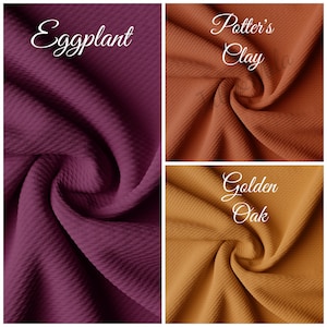 May include: Three fabric swatches in different colors: eggplant, potter's clay, and golden oak. The fabric is a waffle knit with a textured surface.