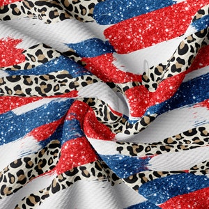 May include: Red, white, and blue glitter stripes with a leopard print pattern. The fabric is folded and textured.