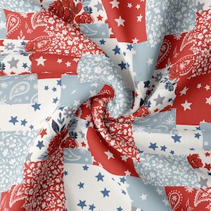 May include: A close-up of a fabric with a patchwork design. The fabric features red, white, and blue squares with floral, paisley, and star patterns. The design evokes a patriotic theme, with a mix of textures and patterns.