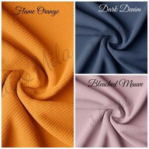 May include: Close-up of three fabric swatches in different colours: Flame Orange, Dark Denim, and Bleached Mauve. The fabric has a textured waffle weave.