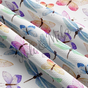 May include: A white background with a repeating pattern of watercolor butterflies and dragonflies in various colors, including pink, blue, purple, green, and yellow.