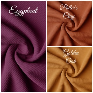 May include: Three fabric swatches in different colours: eggplant, potter's clay, and golden oak. The fabric is a waffle knit with a textured surface.