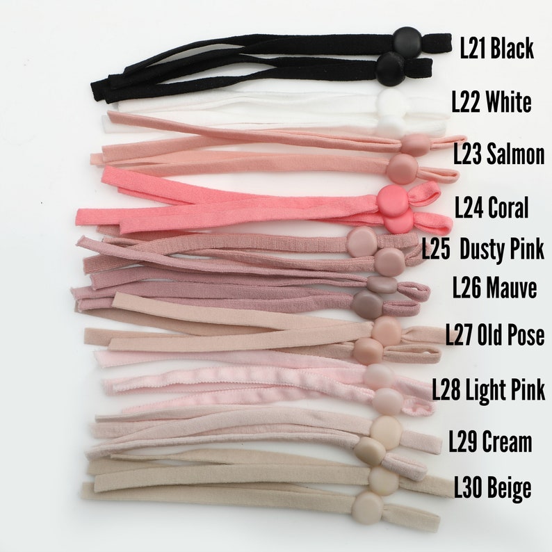 May include: A variety of colors of fabric mask straps with adjustable toggles. The colors include black, white, salmon, coral, dusty pink, mauve, old rose, light pink, cream, and beige.