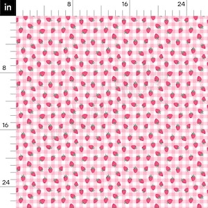 May include: Pink and white gingham fabric with a repeating pattern of small red strawberries.