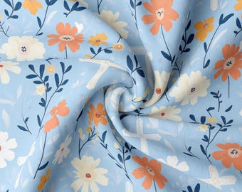 May include: A light blue fabric with a floral pattern featuring white, orange, and yellow flowers. The fabric also has a white cross pattern.