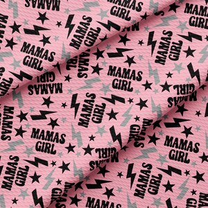 a pink background with black stars and the words mama's girl