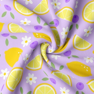 May include: A purple fabric with a repeating pattern of yellow lemons, white daisies, and purple blueberries.