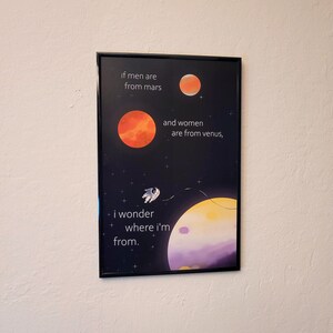 May include: A black and white illustration of a space scene with planets, stars, and an astronaut. The text reads "if men are from mars and women are from venus, i wonder where i'm from."