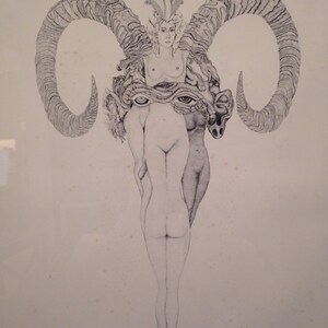 May include: A black and white line drawing of a woman with a crown of feathers standing between two ram horns. The woman's face is visible, and she is wearing a long, flowing gown. The ram horns are large and curved, and they are positioned behind the woman's head.