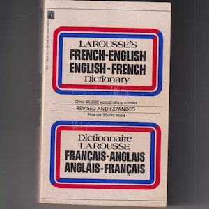 May include: A Larousse French-English, English-French dictionary. The cover features red, white, and blue rectangular borders with the title in English and French. The book is revised and expanded, with over 35,000 vocabulary entries.