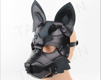 May include: Black leather dog mask with ears, a muzzle, and adjustable straps. The mask is on a mannequin head.