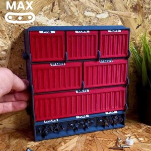 May include: A red and blue wall-mounted organizer with six small drawers labeled "Pins", "Clips", "Nuts", "Spares", "Screws", and "Bolts". The organizer has a bottom row with three compartments labeled "Philips", "Torx", and "Hex".