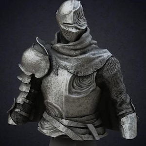 May include: A silver-colored bust of a knight wearing a helmet and chainmail armor. The knight has a dark cloth covering the neck and shoulders. The bust is on a plain base.