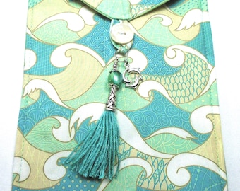 Stylized crashing waves in blue green teal white handmade quilted tarot bag handmade green tassel green & silver beads silver dolphin charm